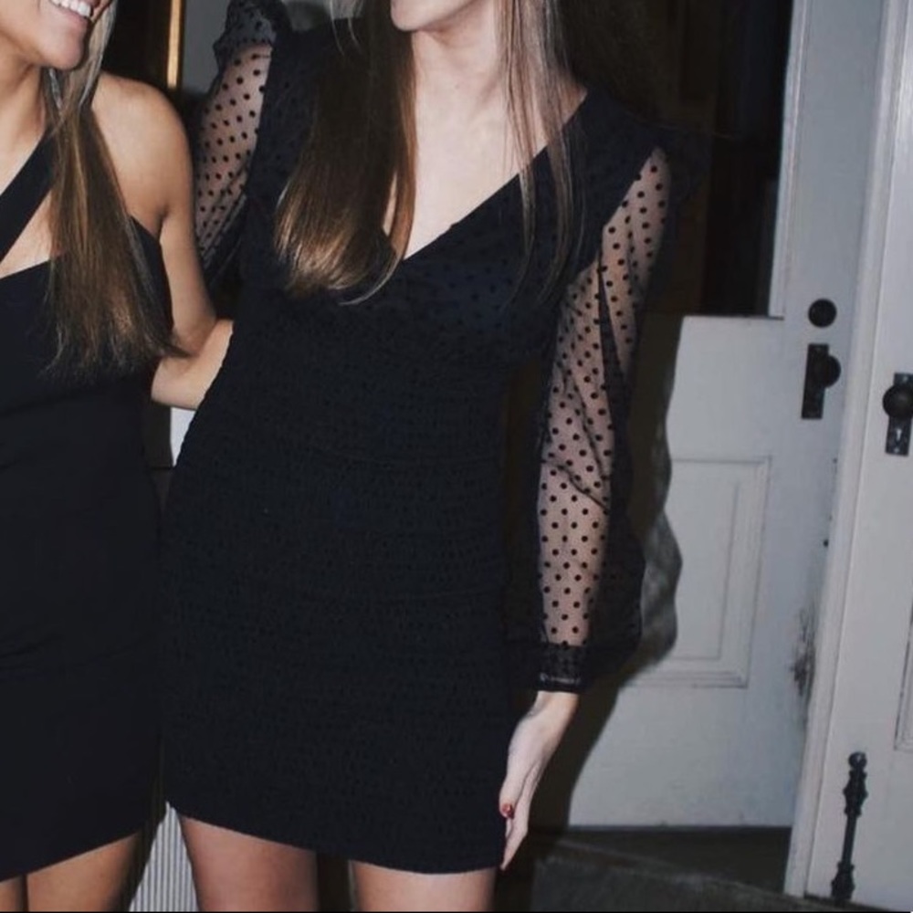 Likely black long sleeve dress
